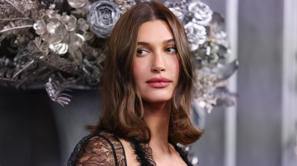 Hailey Bieber posing in a black lace dress